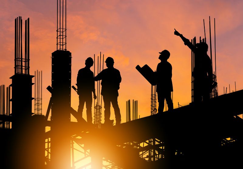 Silhouette of Engineer and worker on building site